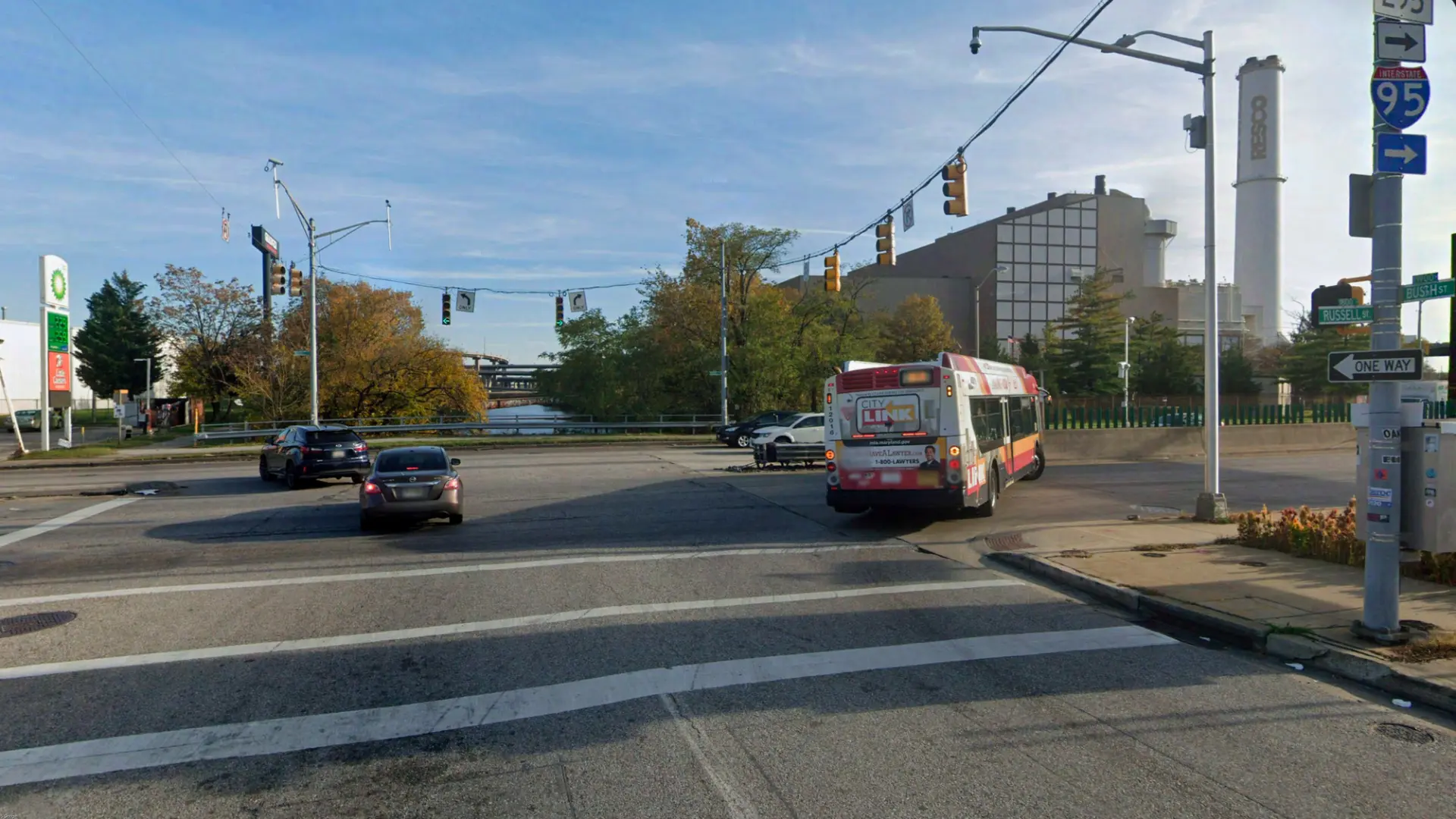 Russell Street at Bush Street today, wide asphalt intersection with a CityLink bus and the RESCO stack beyond
